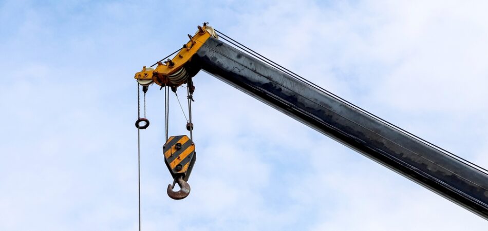 Closeup,of,an,old,lifting,hook,attached,to,sheave,suspended