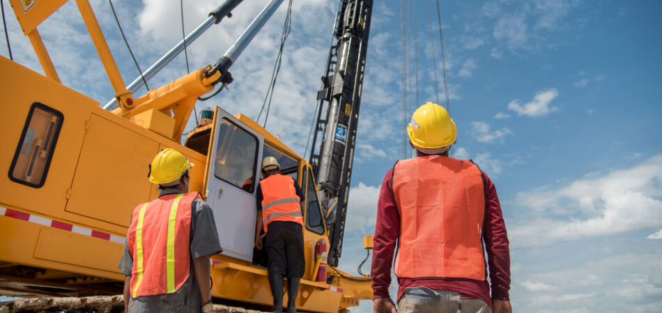 Engineer,and,foreman,looking,at,heavy,machine,assembly,concrete,pile