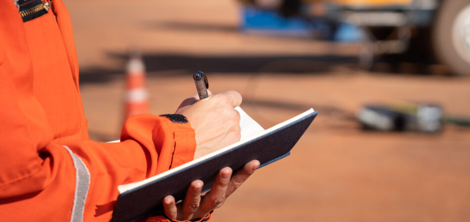 Action,of,safety,officer,is,taking,note,on,checklist,with